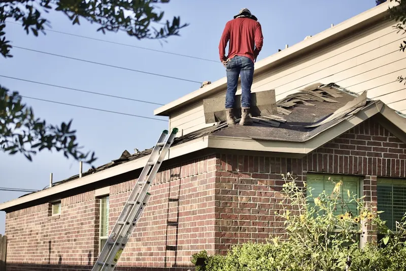 Professional roofer working on a residential roof in Reese